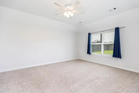 Primary bedroom with large window