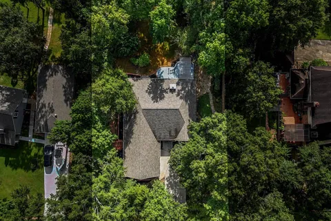 Drone view of the home and wooded lot