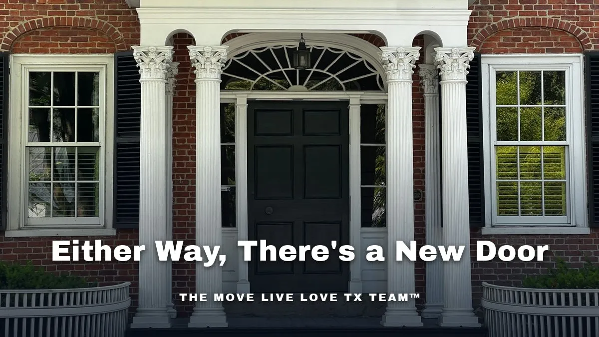 The front entrance of a brick home with white columns, black shutters and a dark front door