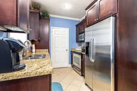 Galley kitchen with pantry and window over the sink