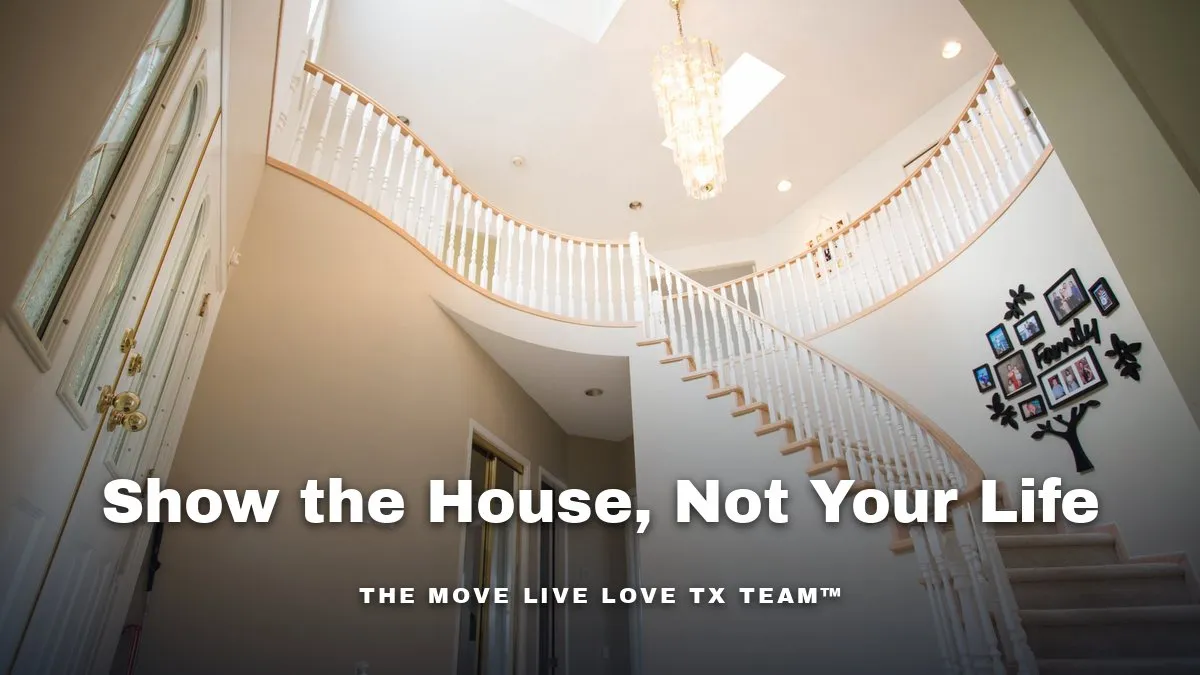 A bright two-story entry foyer with a curved staircase and a crystal chandelier