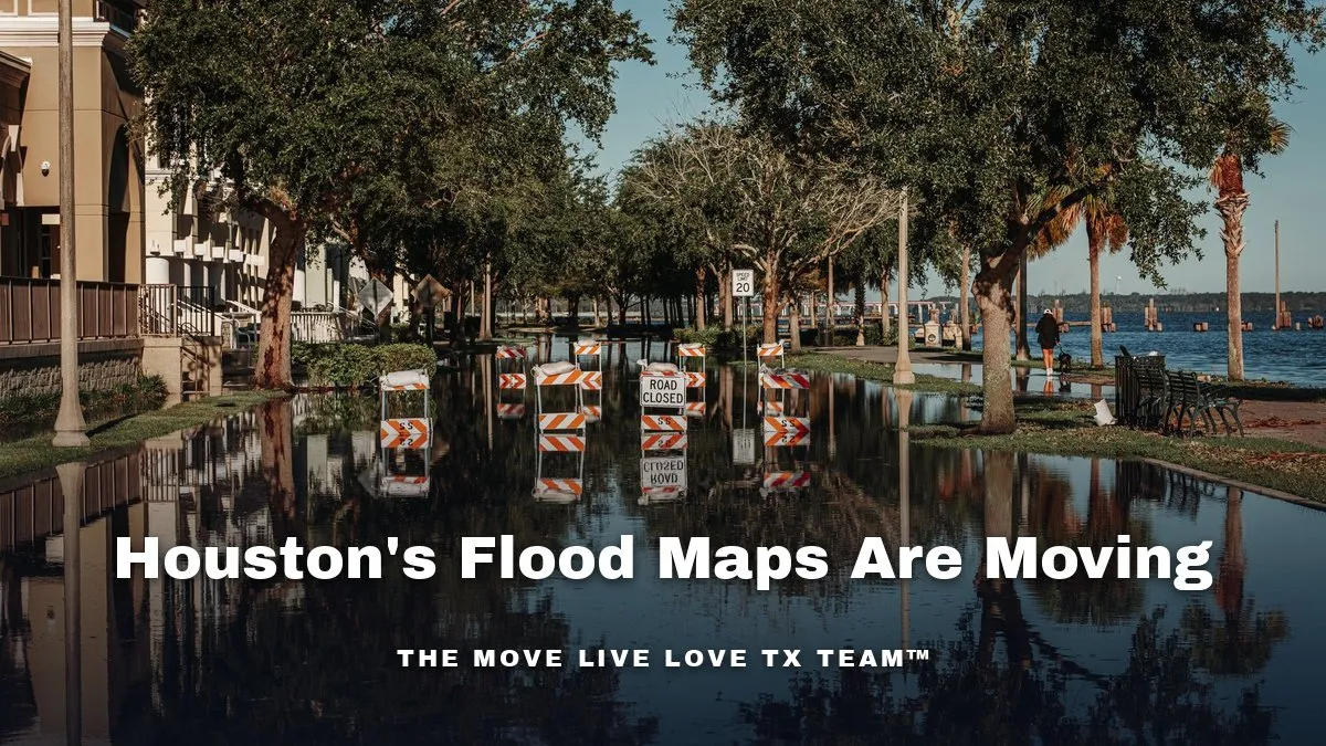 A flooded street lined with trees, with road-closed barricades reflected in the standing water