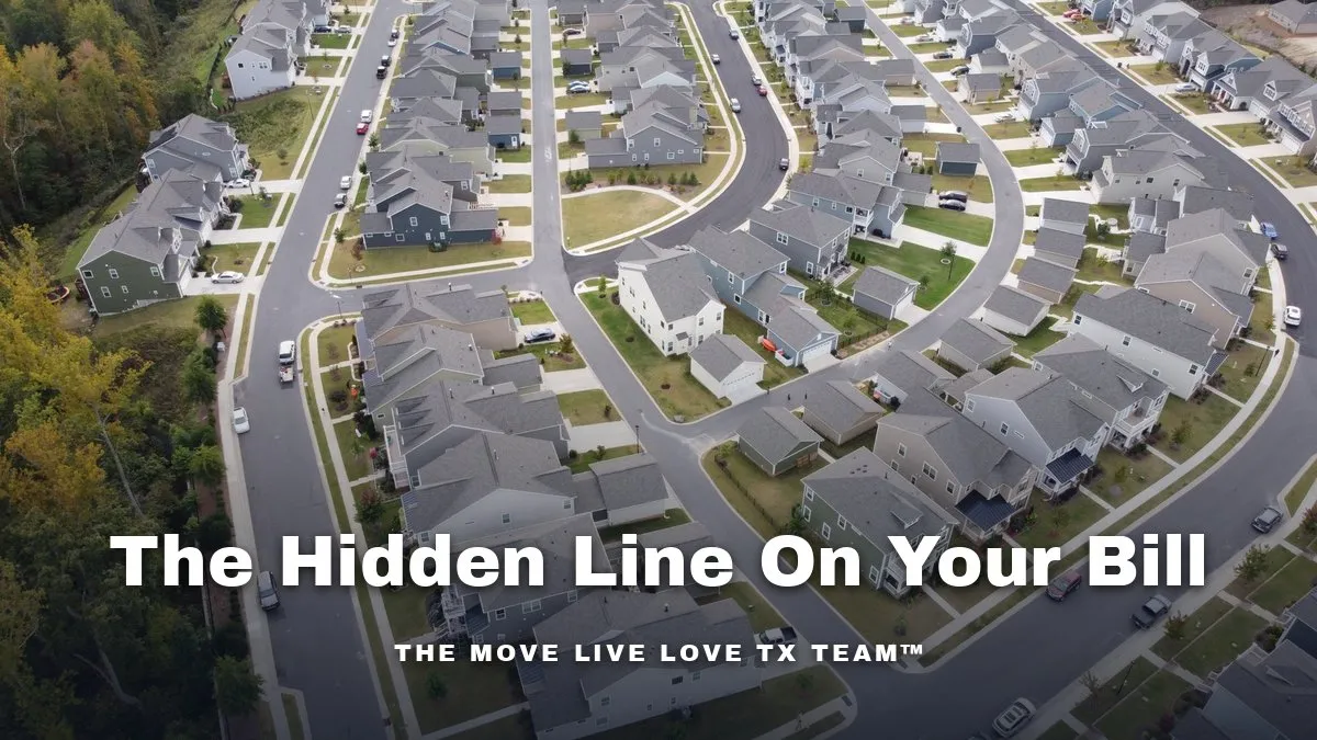 An aerial view of a newly built subdivision with rows of two-story homes along curving streets beside a stand of trees