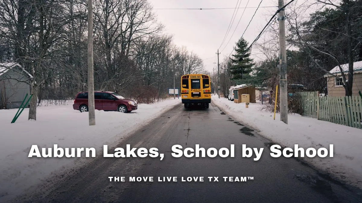 A yellow school bus parked on a tree-lined suburban street on a sunny day