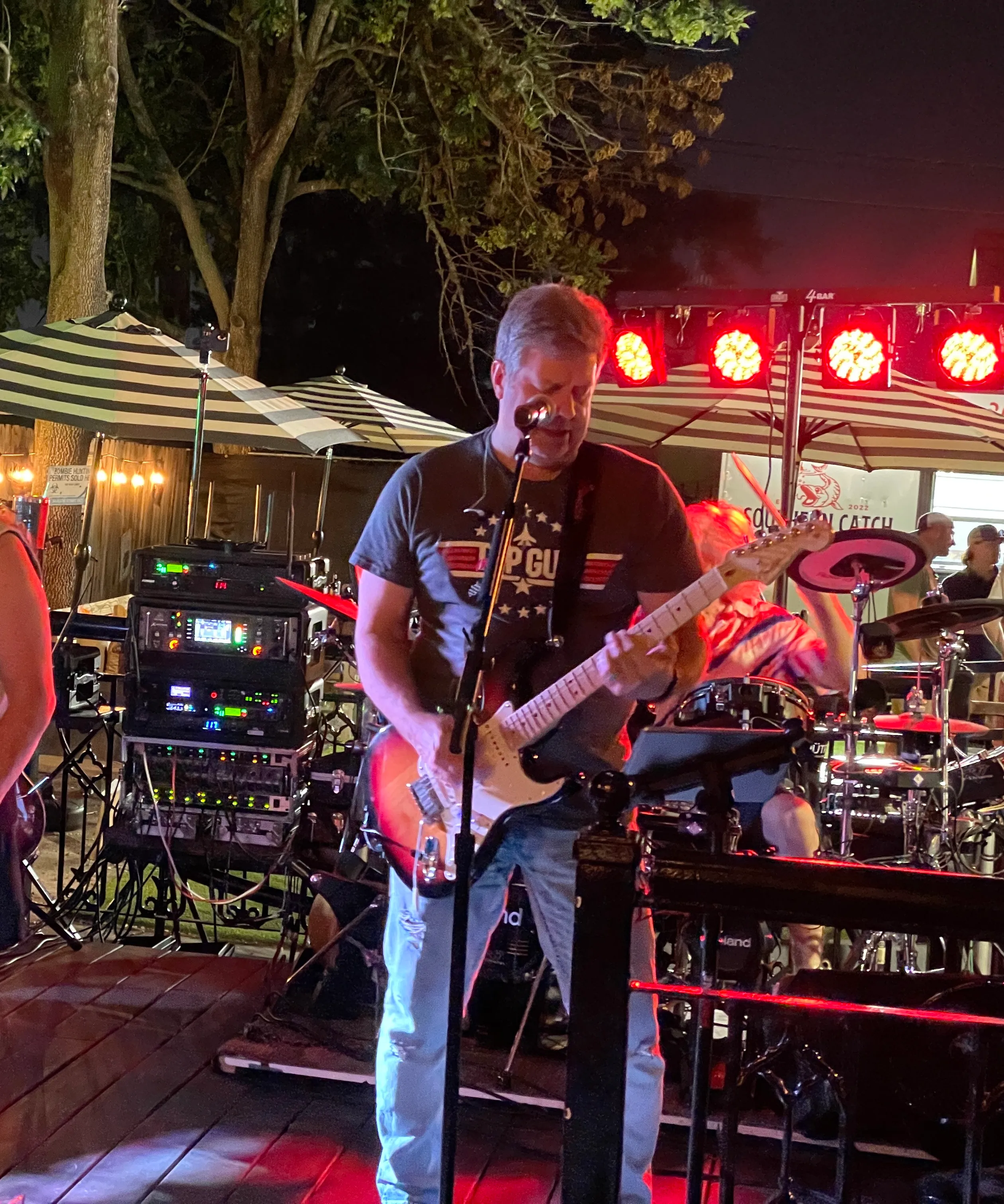 Peter playing guitar on stage with his band, Time Warp