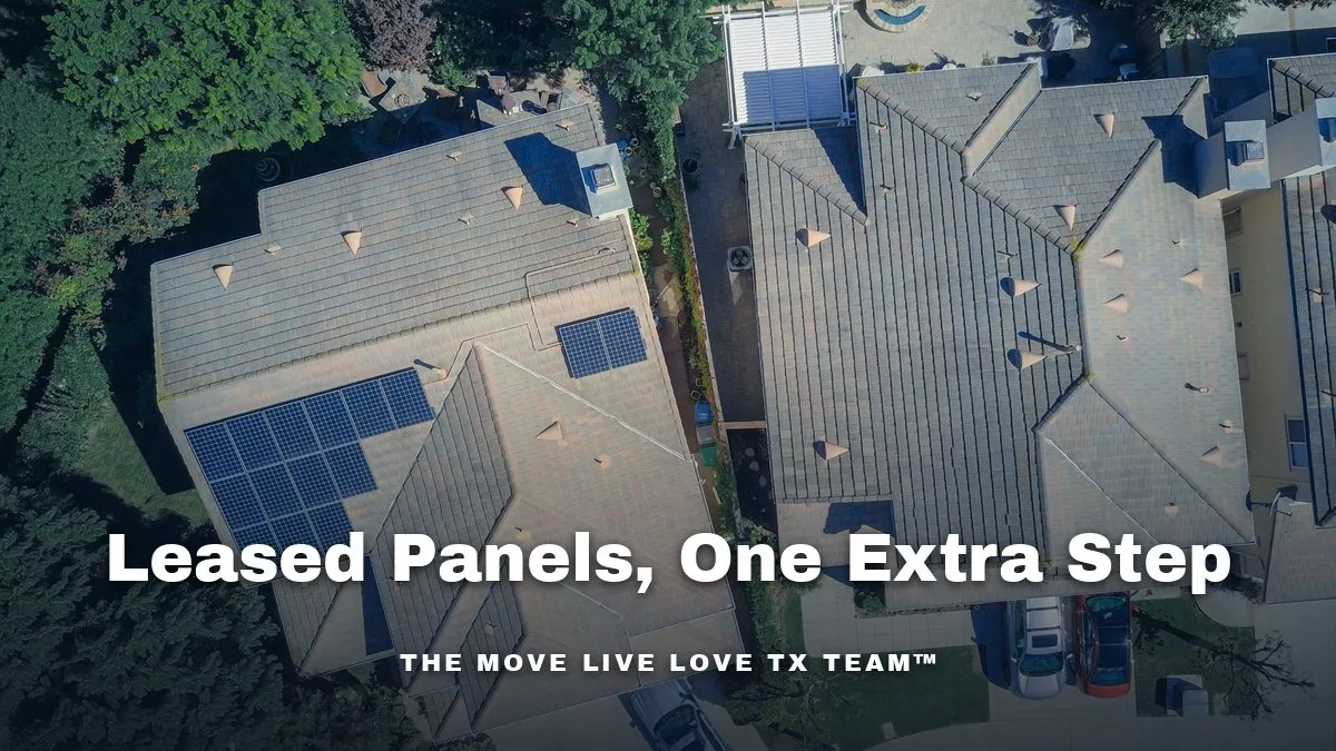An overhead view of two neighboring suburban homes, one with solar panels across its tile roof